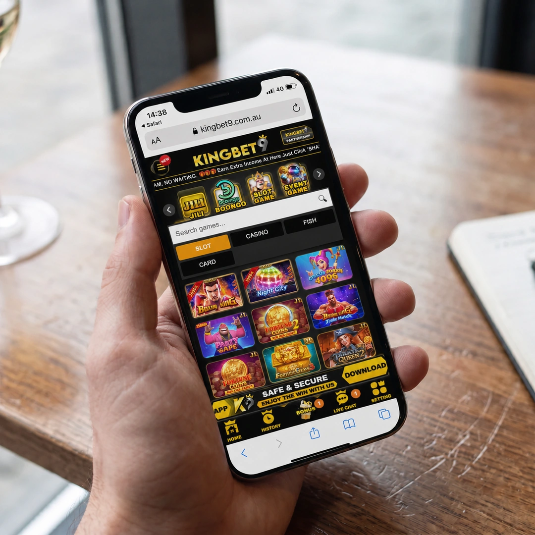 An iPhone 13 in hand running the KingBet9 mobile casino in Safari over 4G, a pokie spinning in the browser; the status bar shows network and time.